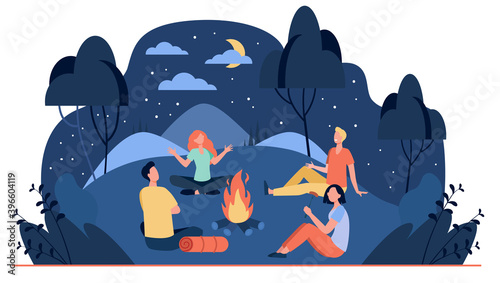 Happy friends sitting near campfire at summer night flat vector illustration. Cartoon people telling scary story near fire. Summertime camping and nature recreation concept photo