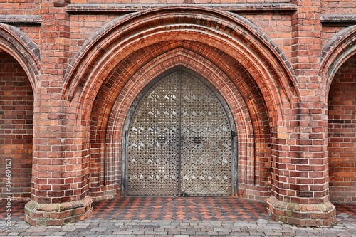 Thick metal gates on brick wall