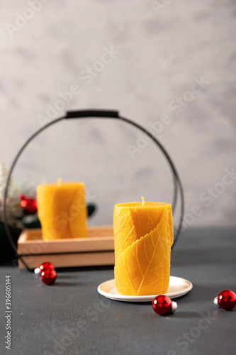 wax candles in the New Year's interior, with red small balls on a dark background