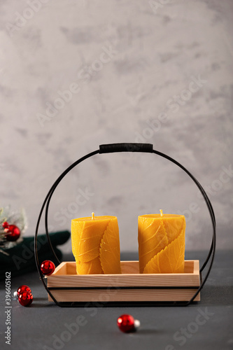 wax candles in the New Year's interior, with red small balls on a dark background