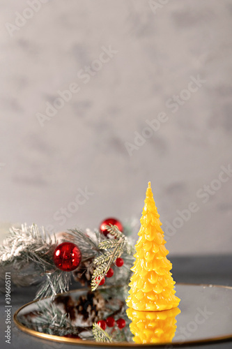 wax candles in the New Year's interior, with red small balls on a dark background