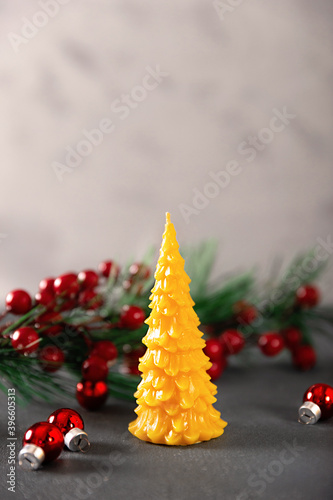 wax candles in the New Year's interior, with red small balls on a dark background