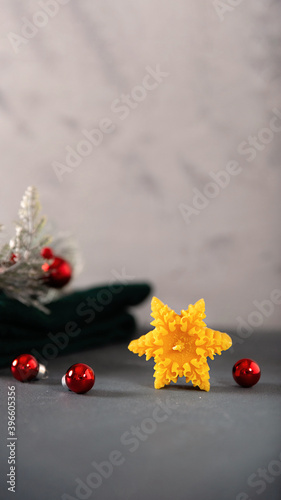 wax candles in the New Year's interior, with red small balls on a dark background