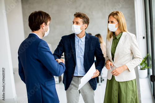 Two men and woman discussin...