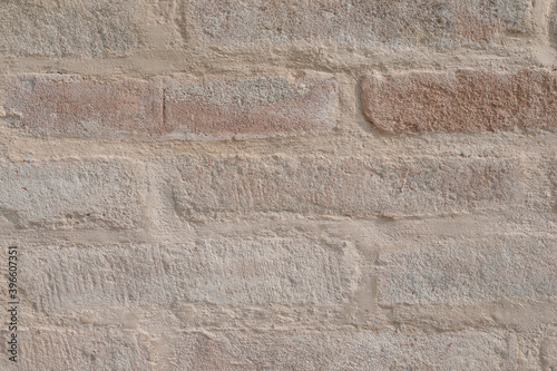 Even brick wall with beige cement wall,empty wall with space for text and a background