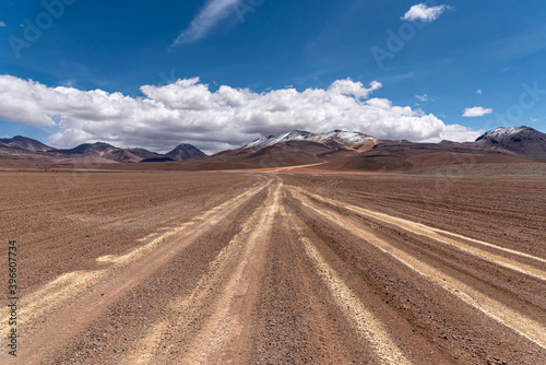 Snow mountains and empty road in the southwest of the the Andean Highlands