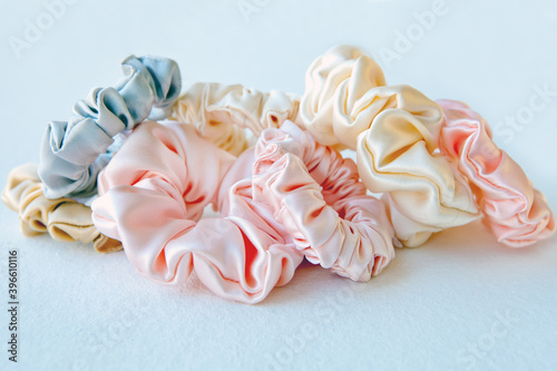 Lot of Colorful silk Scrunchies on white. Flat lay Hairdressing tools and accessories. Hair Scrunchies, Elastic HairBands, Bobble Sports Scrunchie Hairband photo
