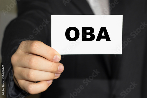 Card with text OBA on hand. You can use in business, marketing and other concepts. Messege of the day. photo