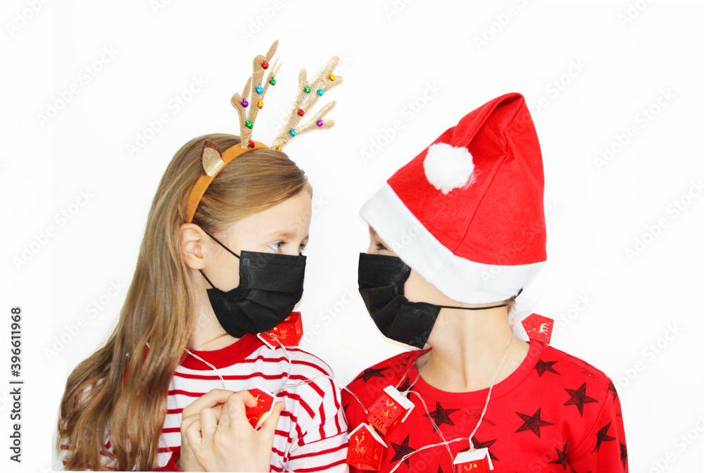 quarantined Santa and his reindeer, beautiful girl red sweater Christmas and New Year's gift. Happy little girl and boy in santa hat black protective black mask on white background banner, christmas