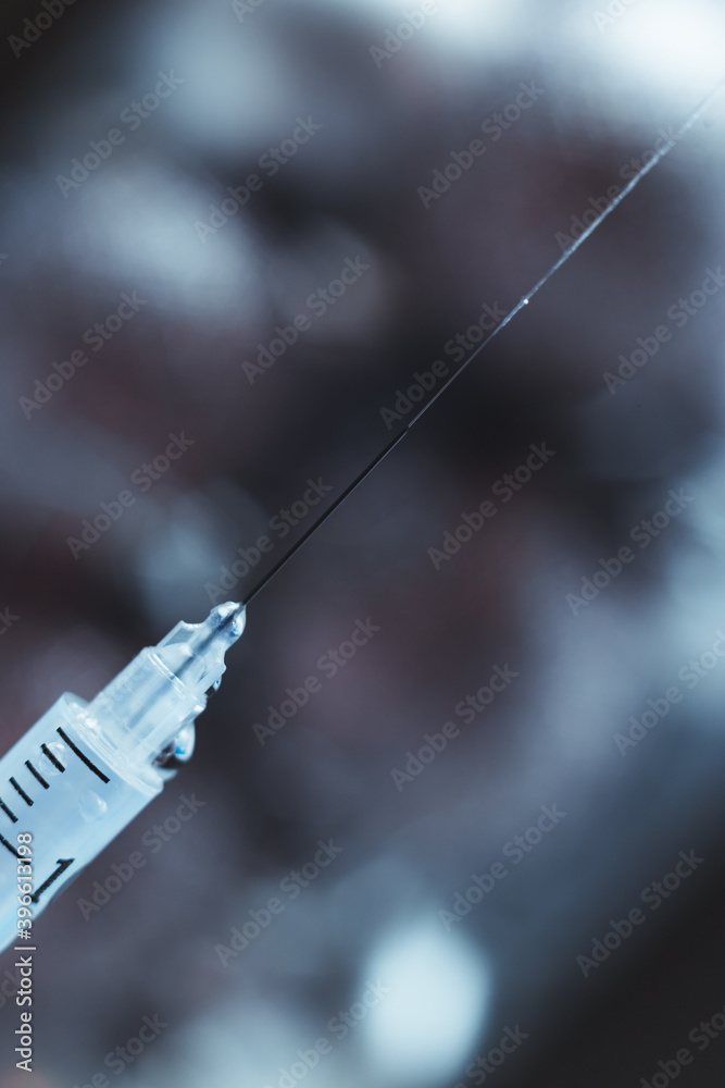 Syringe with needle up and jet and drops of medicine close up Syringe with needle up and jet and drops of medicine close up