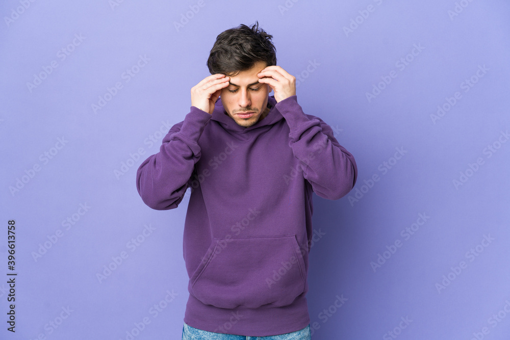 Young cool man touching temples and having headache. Young cool man touching temples and having headache.