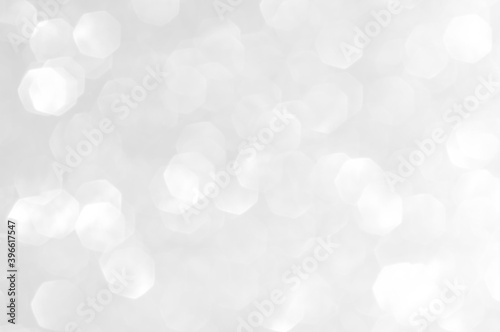 Abstract bokeh white,light grey,sliver colors de focused circular background.Night light season greeting elegance backdrop or artwork design for newyear,christmas sparkling glittering or special day.