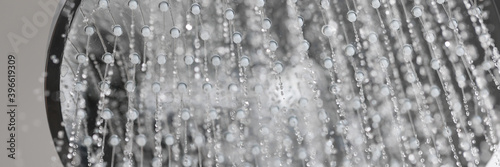 Water is pouring from the shower tap. Daily body hygiene concept photo