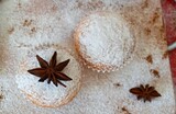 Christmas composition: Christmas cupcake decorated with icing and surrounded by cinnamon, powdered sugar and star anises