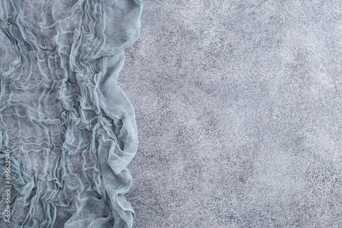 Gauze tablecloth on concrete background. Top view, with copy space photo