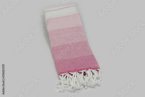 Peshtemal Turkish bath cotton towel folded textile. Beautiful bright colors with natural light background. Perfect online market digital shop sales. photo