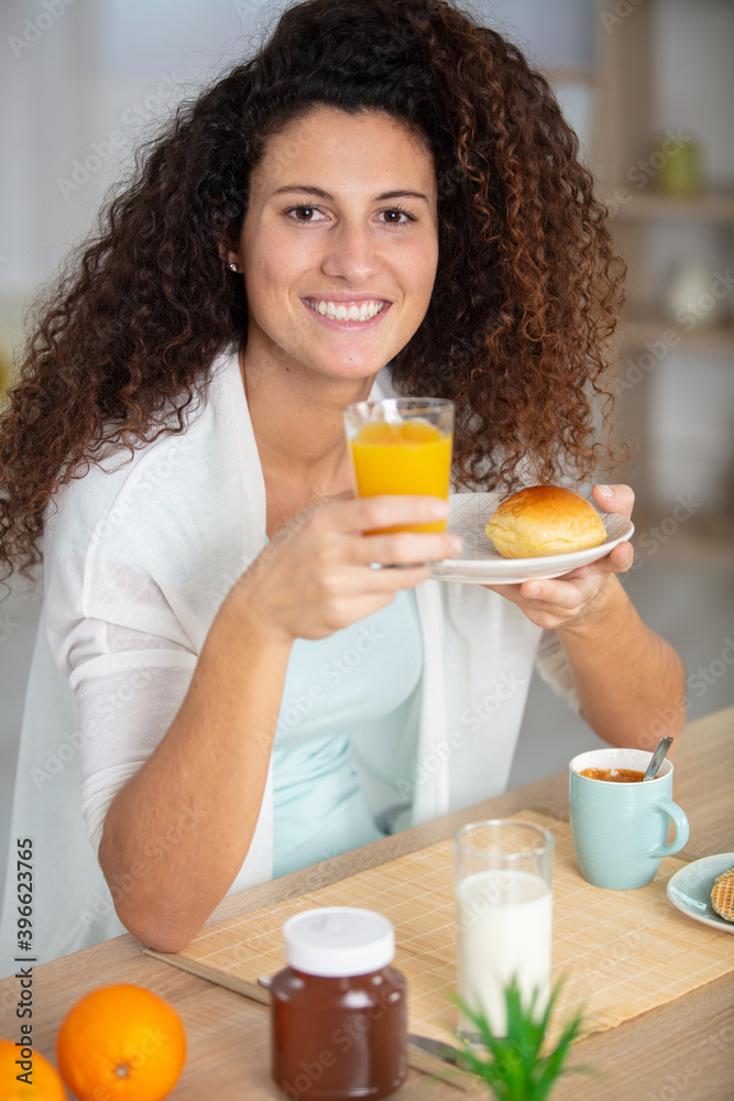 happy woman with brown hair having breakfast happy woman with brown hair having breakfast