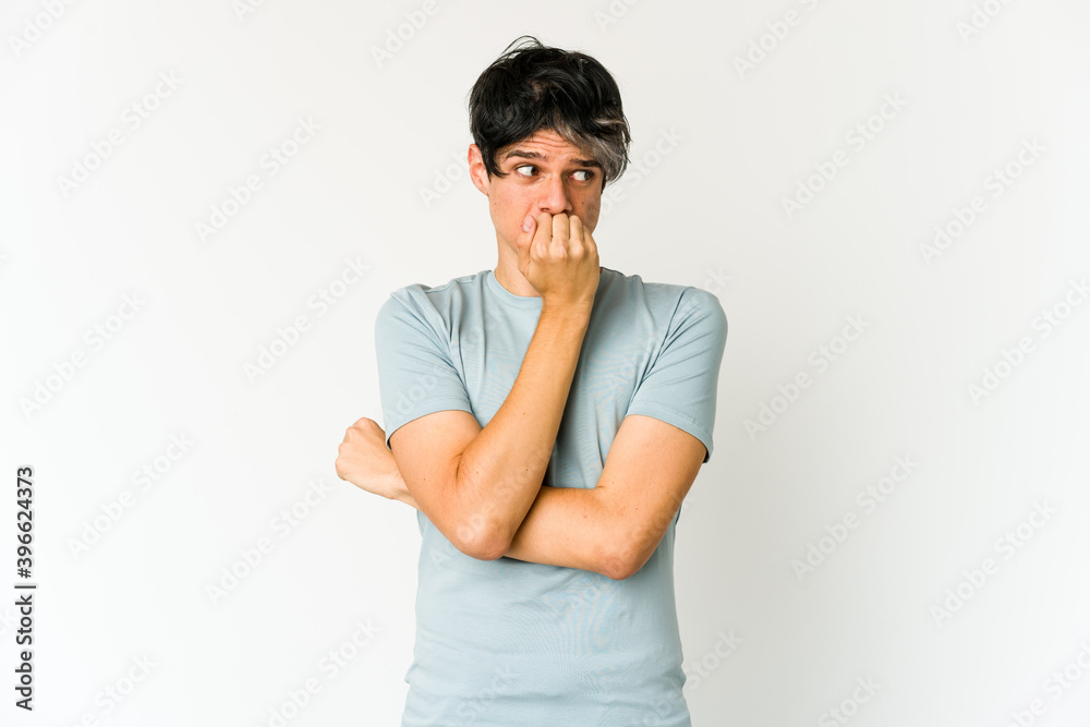 Young skinny hispanic man biting fingernails, nervous and very anxious. Young skinny hispanic man biting fingernails, nervous and very anxious.
