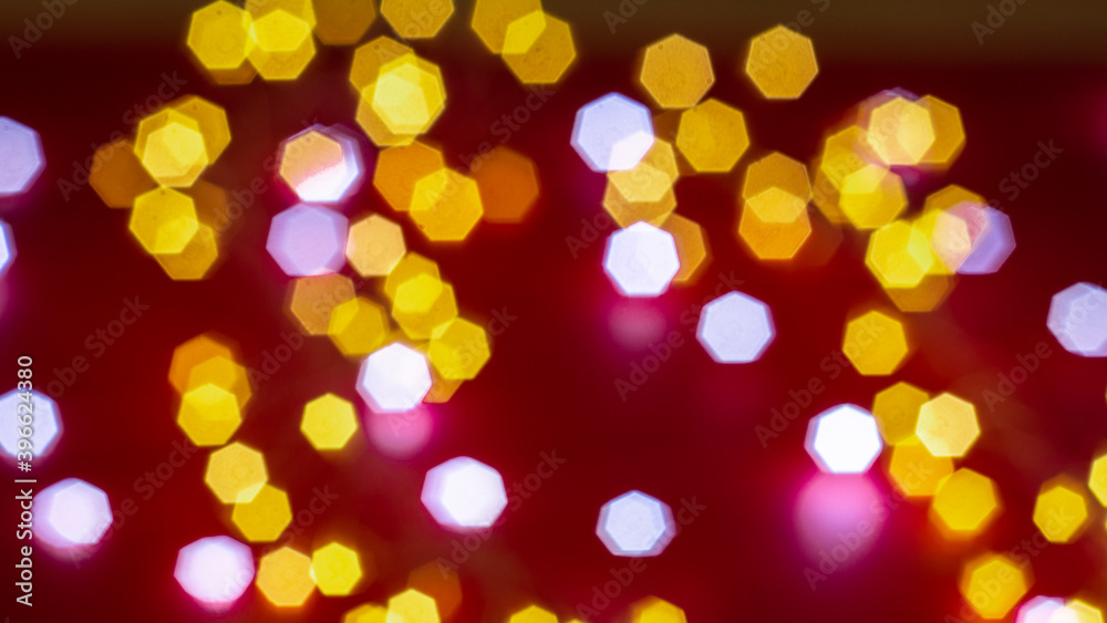 Background of defocused lights of different colors on red background. Abstract image. Valentine, love, passion and party concept