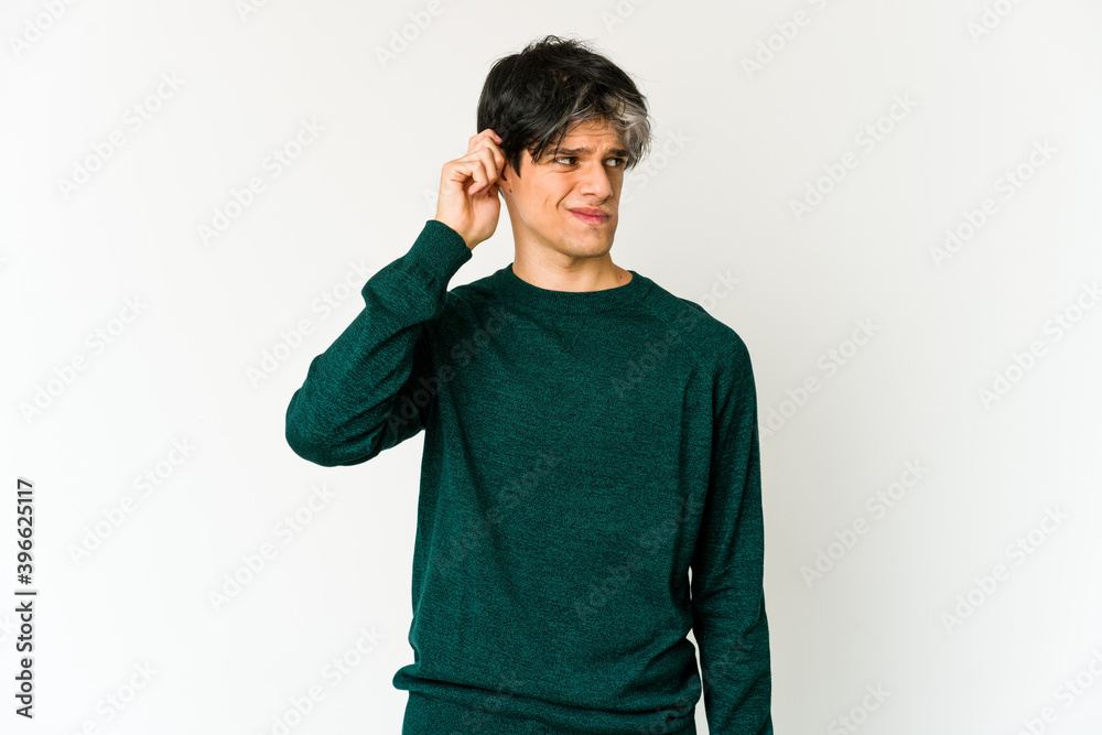 Young skinny hispanic man covering ears with fingers, stressed and desperate by a loudly ambient. Young skinny hispanic man covering ears with fingers, stressed and desperate by a loudly ambient.
