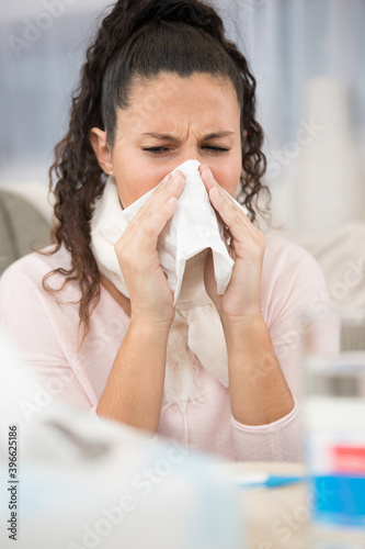 woman feel sick and sneeze at home