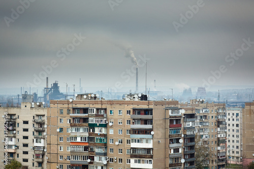 Industrial city. Residential buildings on the background of smoky chimneys of factories. Ecology. photo