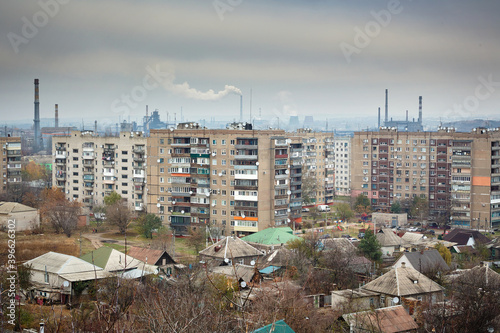 Industrial city. Residential buildings on the background of smoky chimneys of factories. Ecology.