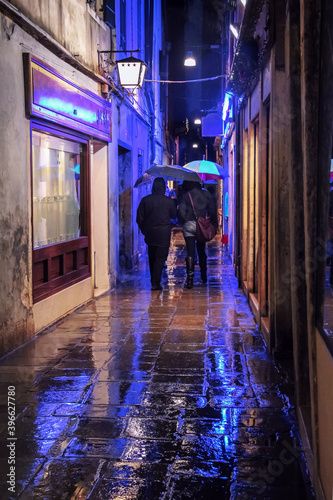 people on a rainy street with lights in Venice © Ira