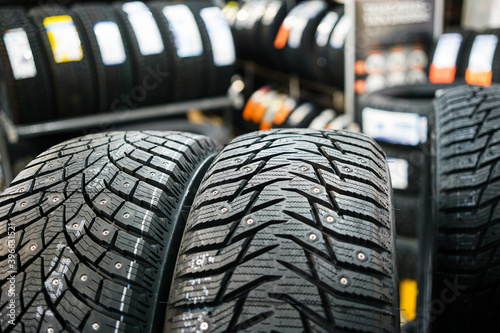 closeup of the tread of two different studded winter tires photo