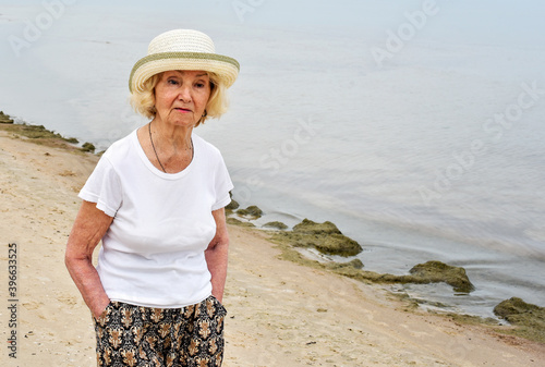 happy elderly woman walking near the sea