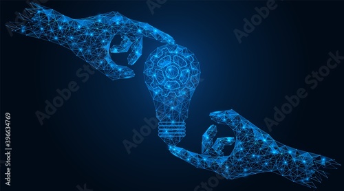 Light bulb in hand. The concept of a joint business idea mechanism. Low-poly construction of concatenated lines and dots. Blue background.