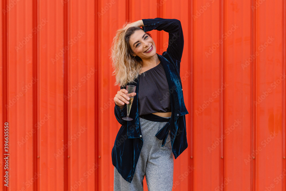 Fototapeta premium Funny young blonde woman girl on red background. Happy New Year.