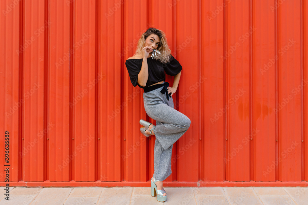 Funny young blonde woman girl on red background. Happy New Year. Funny young blonde woman girl on red background. Happy New Year.