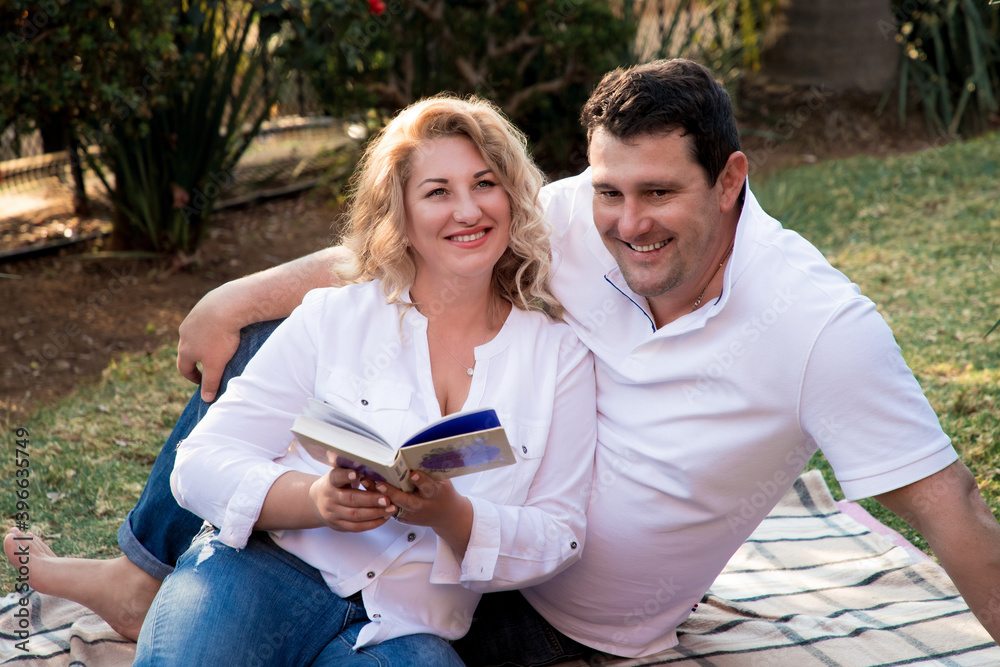Married couple resting on a picnic in the garden Married couple resting on a picnic in the garden