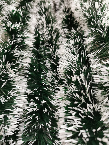 Christmas decor green tinsel blurred background  top view. New Year s background. Christmas background.