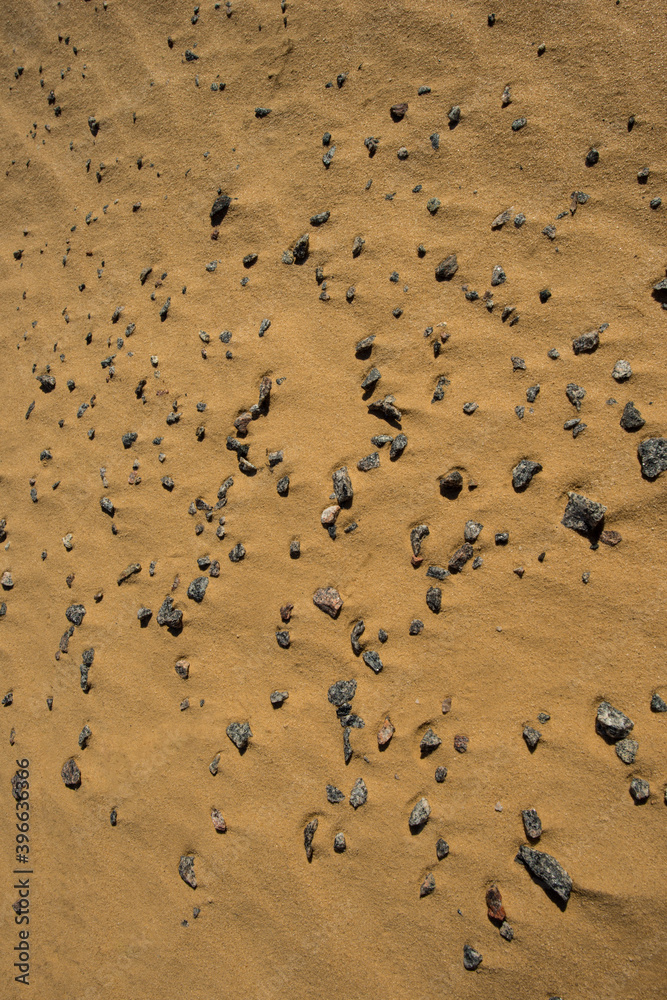 crushed granite and sand surface illuminated by sunlight. crushed granite and sand surface illuminated by sunlight.