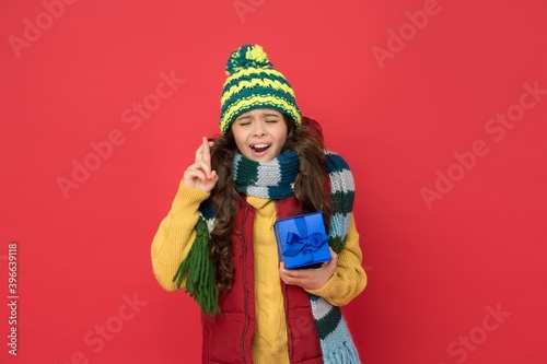 make a wish. enjoy shopping. ready for holidays. boxing day. autumn season fashion. teenage girl in woolen garment with gift. warm clothing trends. happy childhood. kid in knitwear hold present box