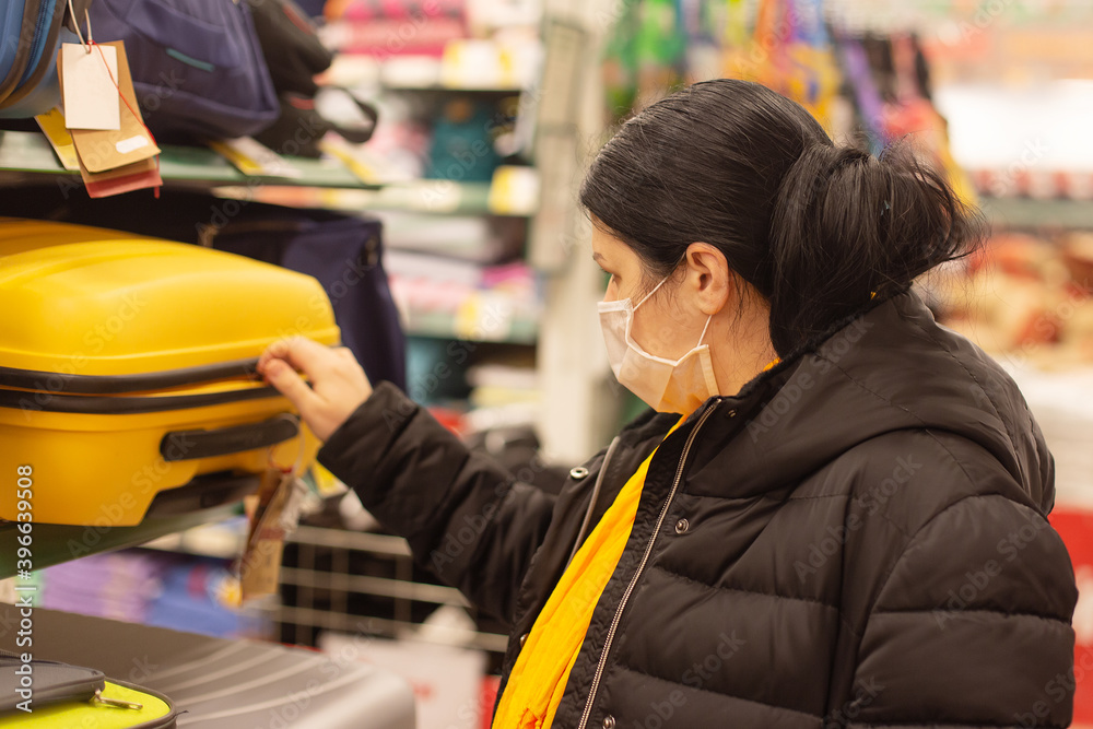 Fototapeta premium Woman in protective mask, supermarket, things