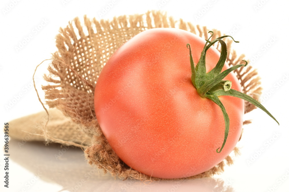Naklejka premium Juicy, pink tomatoes, close-up, on a white background.