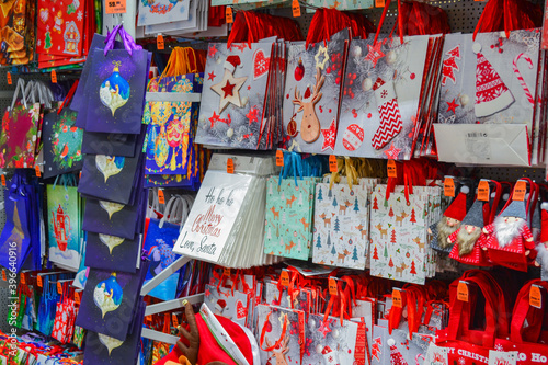 Moscow, Russia, November 2019: a Lot of paper gift bags for new year and Christmas gifts with bright patterns, red color are sold in the store © Yulia