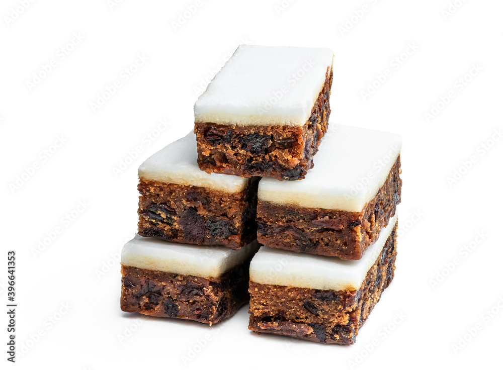 Fruit cake slices topped with marzipan isolated on white Fruit cake slices topped with marzipan isolated on white