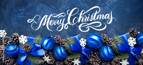 Merry Christmas hand drawn text,  calligraphic lettering design card with blue balls. Holiday Greeting Gift Poster.