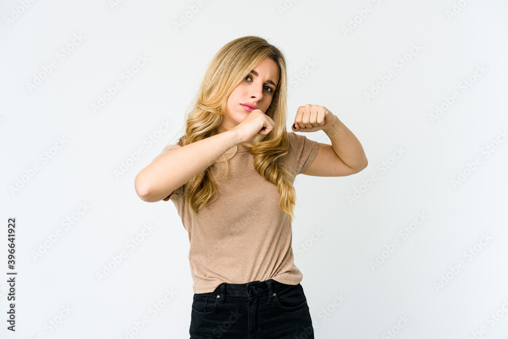Young caucasian blonde woman throwing a punch, anger, fighting due to an argument, boxing. Young caucasian blonde woman throwing a punch, anger, fighting due to an argument, boxing.