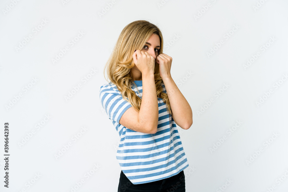 Young caucasian blonde woman throwing a punch, anger, fighting due to an argument, boxing. Young caucasian blonde woman throwing a punch, anger, fighting due to an argument, boxing.