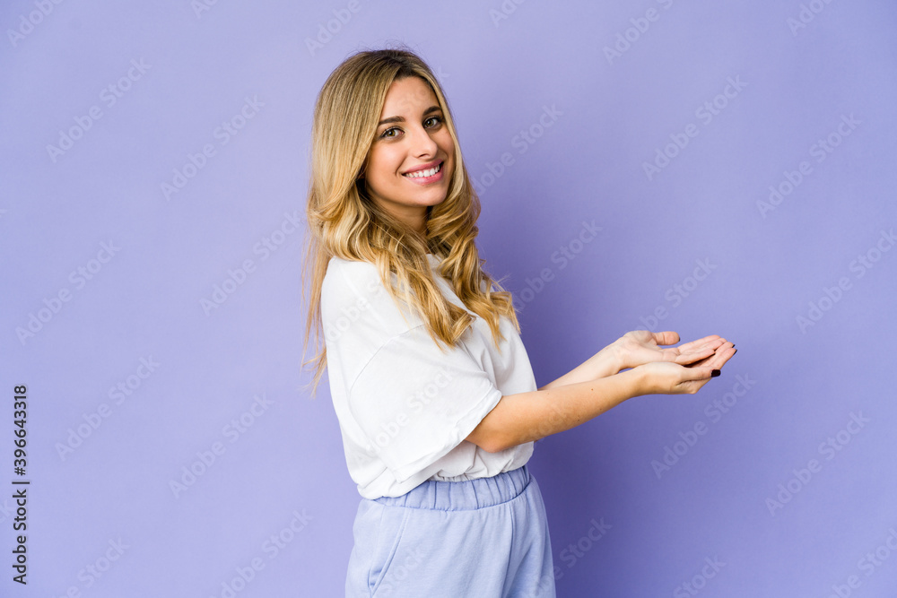 Young caucasian blonde woman holding a copy space on a palm. Young caucasian blonde woman holding a copy space on a palm.