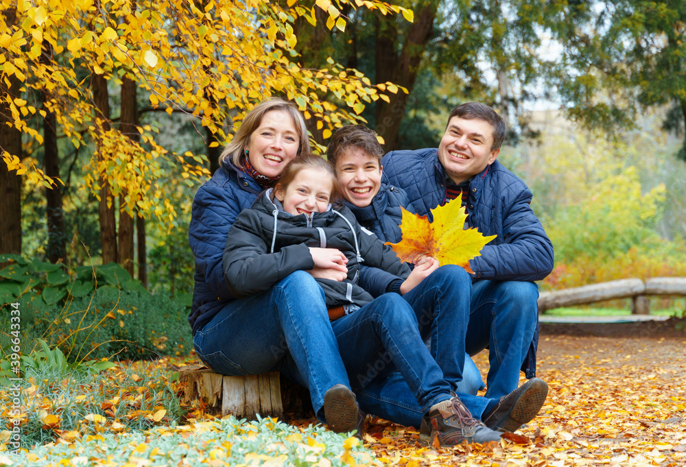 family relaxing outdoor in autumn city park, happy people together, parents and children, they talking and smiling, posing near yellow birch leaves, beautiful nature family relaxing outdoor in autumn city park, happy people together, parents and children, they talking and smiling, posing near yellow birch leaves, beautiful nature