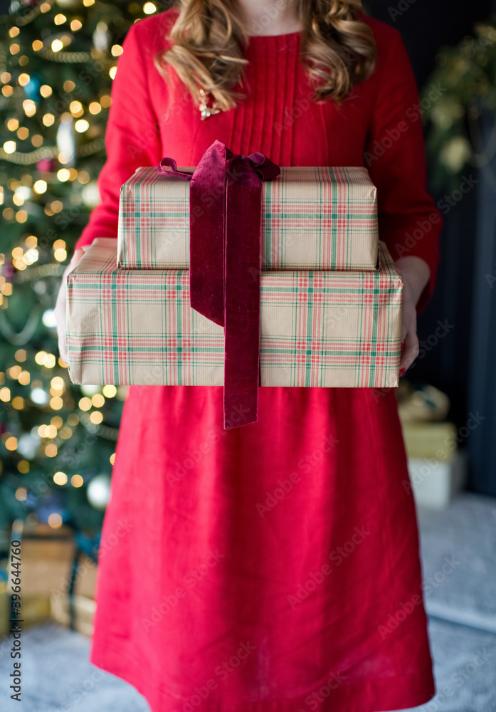 Woman holds Christmas gift boxes