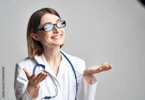 portrait of female nurse in medical gown and blue stethoscope cropped view
