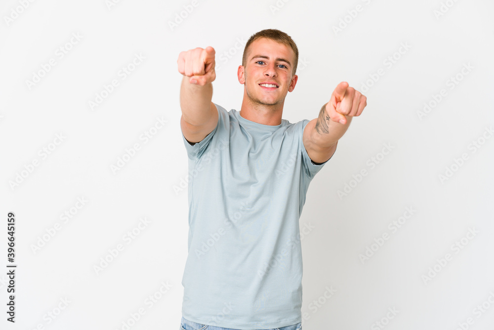 Young caucasian handsome man cheerful smiles pointing to front. Young caucasian handsome man cheerful smiles pointing to front.
