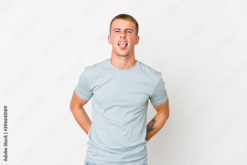 Obraz premium Young caucasian handsome man funny and friendly sticking out tongue.